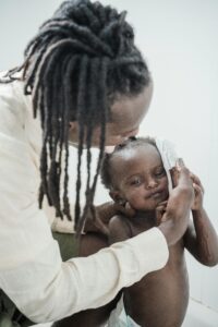 A father lovingly washes his young child at home, creating a tender family moment.